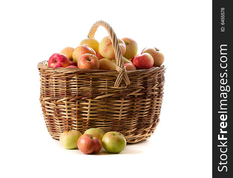 Apples in woven basket isolated on white background