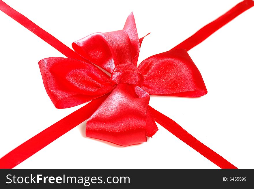 Red satin bow with ribbon isolated on white