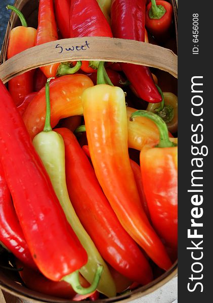 A large basket of peppers at the farmers market