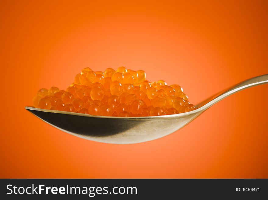 Salmon roe close up over orange background