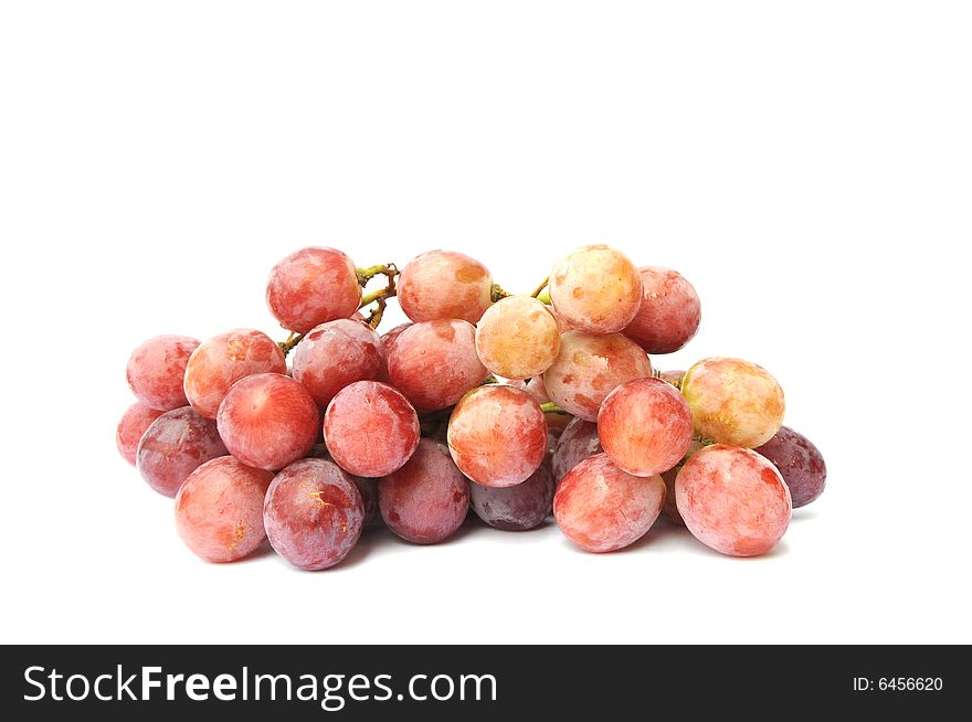 A string of red grapes on the white background.
