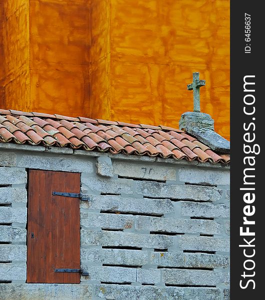 Traditional Galician granary in front of orange facade. Traditional Galician granary in front of orange facade