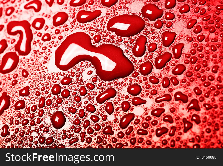 Some water drops on red background