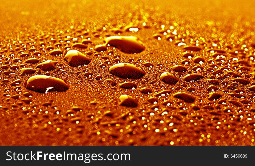 Some water drops on golden background