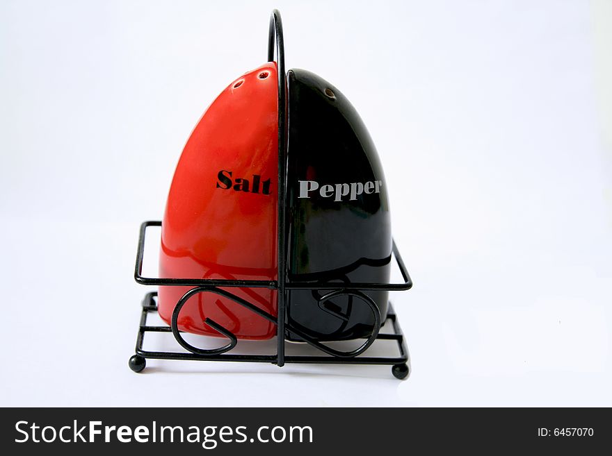 The complete set of a saltcellar and pepperbox isolated on a white background. The complete set of a saltcellar and pepperbox isolated on a white background