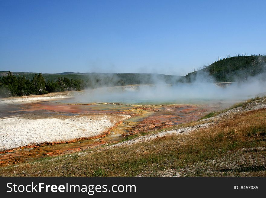 Hot basin with geysers in Yellowstone National Park