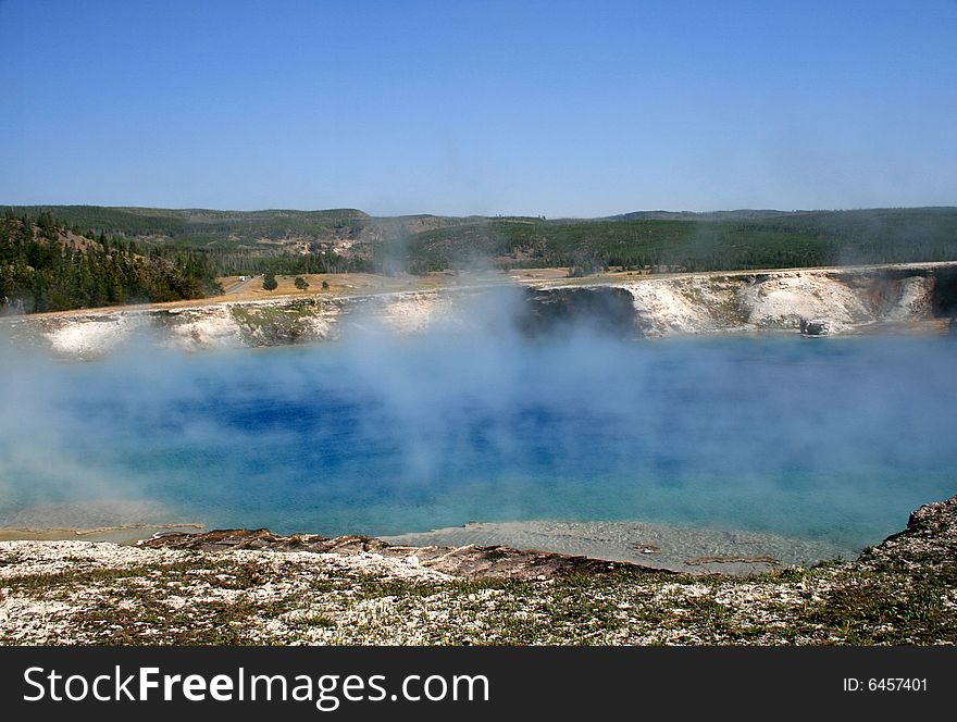 Blue Pool with geysers in Yellowstone National Park