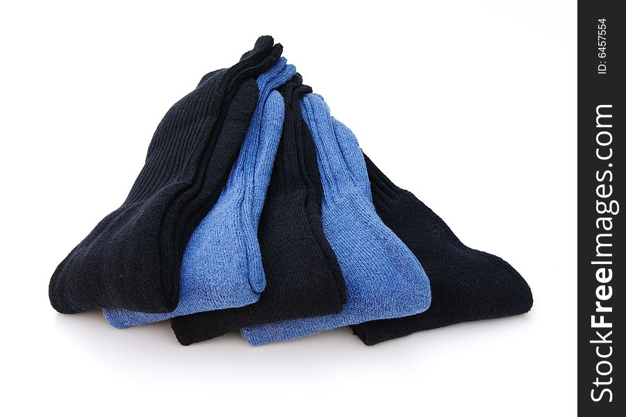 Shot of five pairs of blue socks on white background