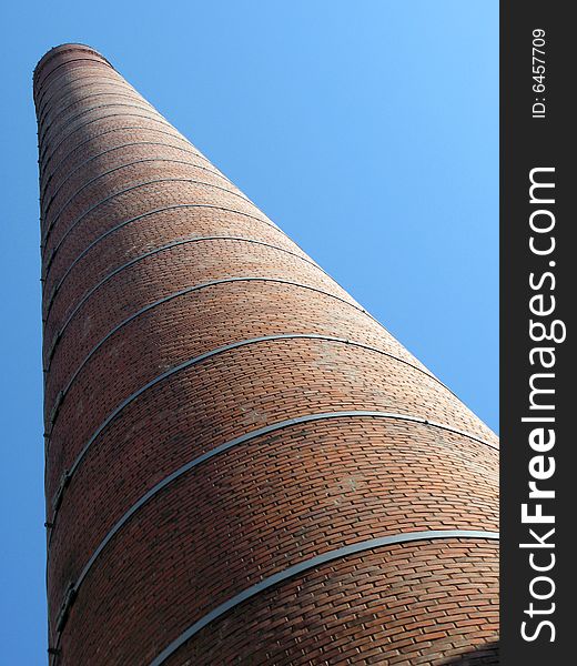 Brick pipe against blue sky