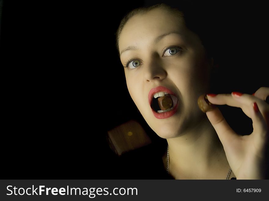 Woman with a dice on a black background with a dice