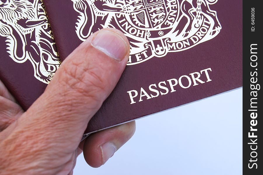 Male hand holding British 10 year passport. Male hand holding British 10 year passport