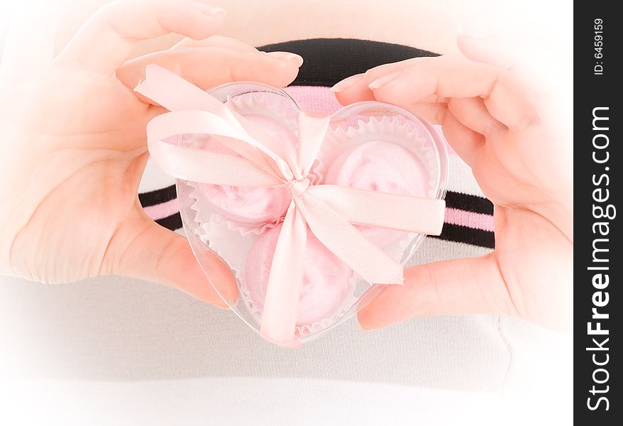 Give you my heart! Girl hold a gift in a nice pink heart shaped box like you own heart