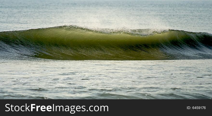 Beautiful wave breaking off shore.  Nice wave for surfing. Beautiful wave breaking off shore.  Nice wave for surfing.