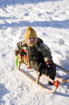 Baby In Green Coat Sitting In Sled Stock Images Baby In Green Coat Sitting In Sled Stock Images