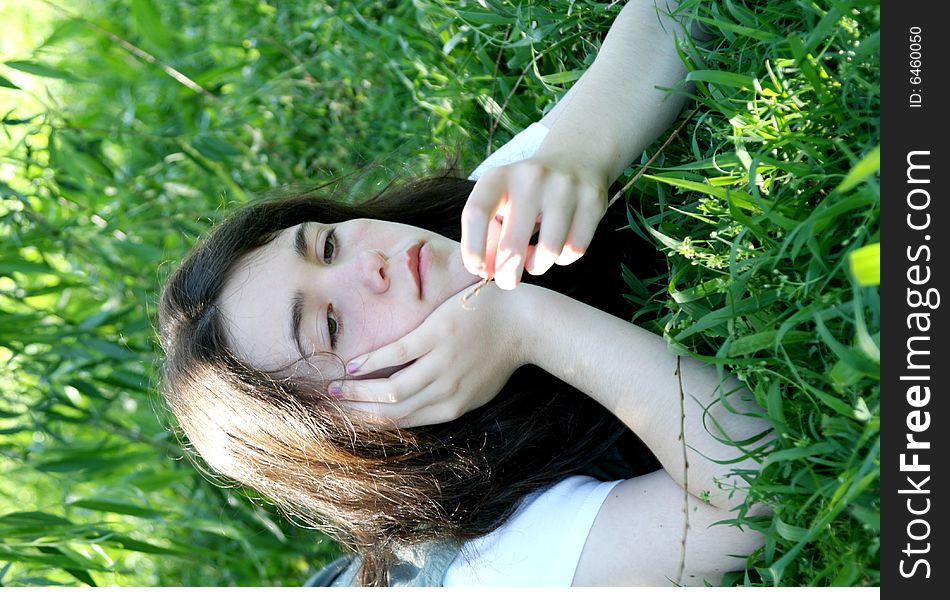 Teen girl thinking under willow tree. Teen girl thinking under willow tree