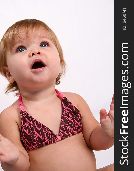 An adorable baby girl surprised while she claps her hands. An adorable baby girl surprised while she claps her hands.