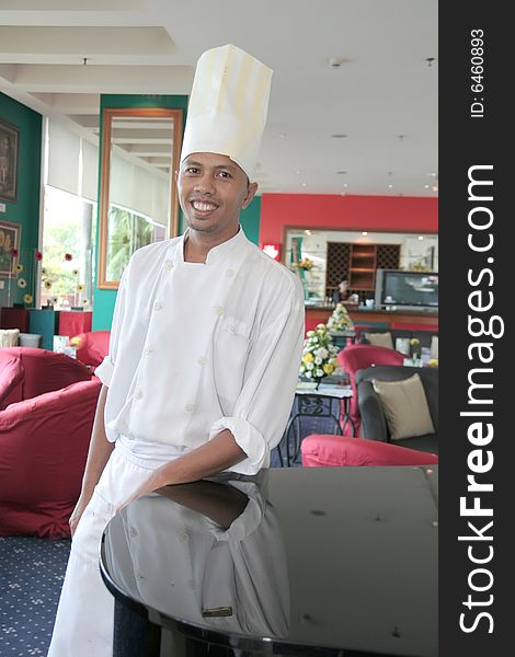 Chef standing at restaurant proud and smiling