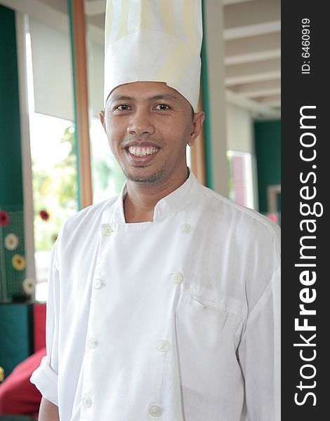 Chef standing at restaurant proud and smiling