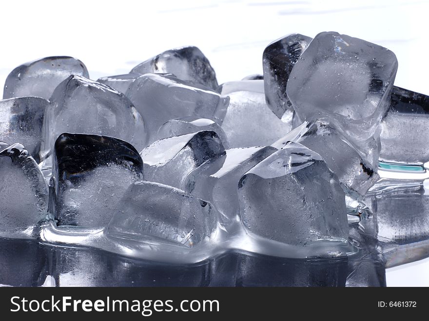 Ice cubes in smooth reflected background