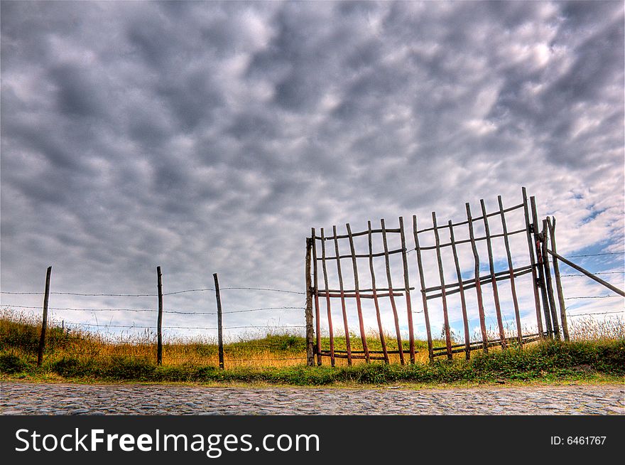 Beautiful hdr scene of a fence and cloudscape. Beautiful hdr scene of a fence and cloudscape