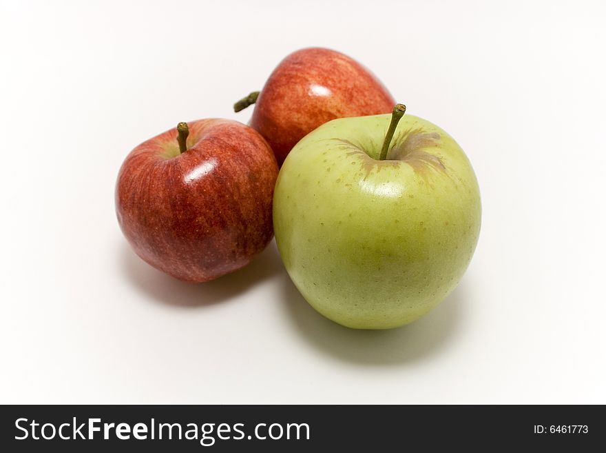 2 red and 1 yellow apple on white background. 2 red and 1 yellow apple on white background