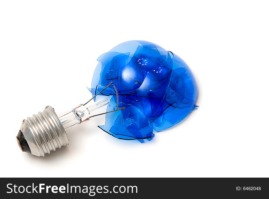 Broken blue light bulb isolated over white. Broken blue light bulb isolated over white