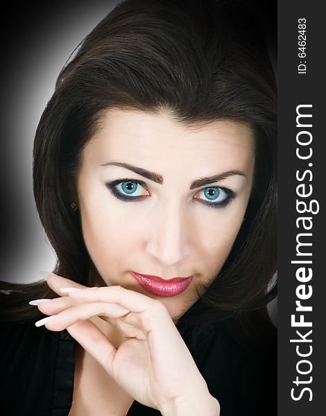 Portrait of the brunette with blue eye on black background