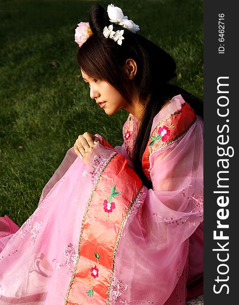 A girl in Chinese ancient dress. 
She is in pondering . A girl in Chinese ancient dress. 
She is in pondering ....