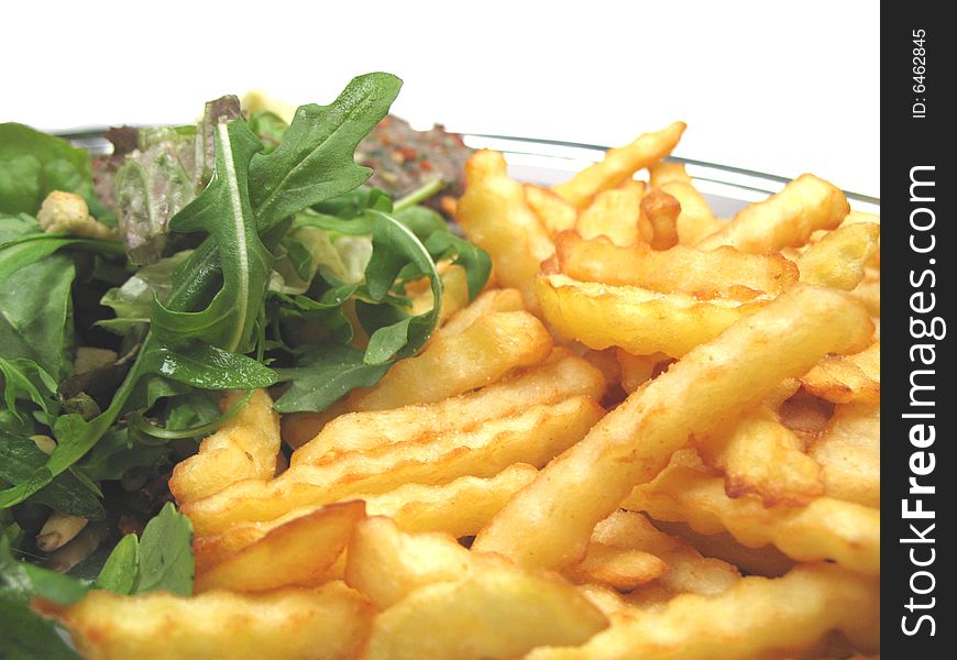 A close-up picture of some chips and a healthy salad