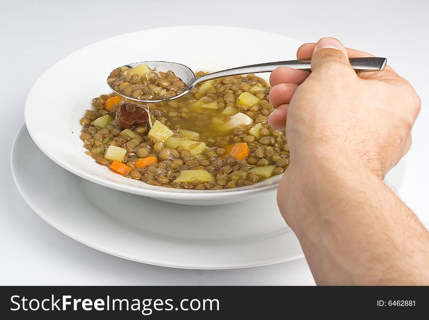 Homemade hot dish of lentils isolated on white