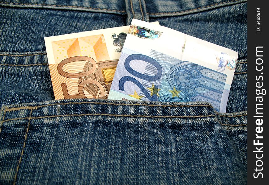 Two banknotes sticking out of a jeans pocket. Two banknotes sticking out of a jeans pocket