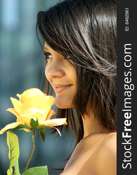 Young woman with a beautiful yellow rose