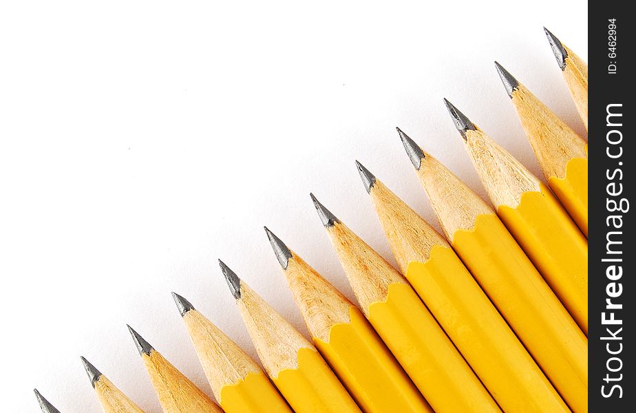 Yellow pencils in line on the white background