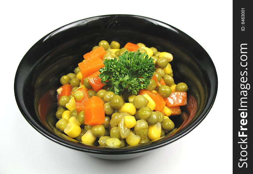 A black bowl with cooked vegetables. A black bowl with cooked vegetables