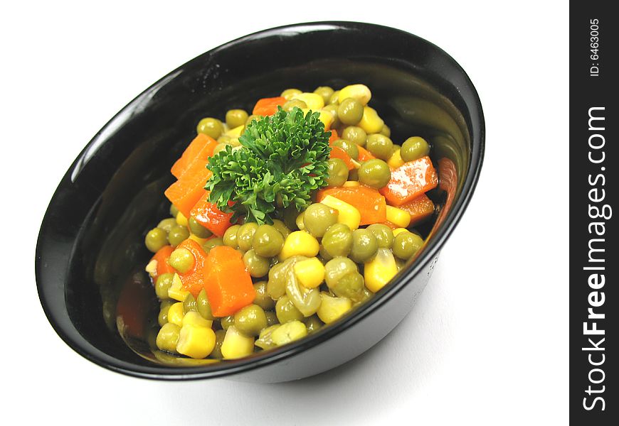 A bowl of vegetables tilted to the left