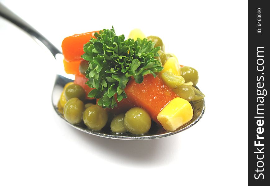 A close-up picture of vegetables on a spoon. A close-up picture of vegetables on a spoon