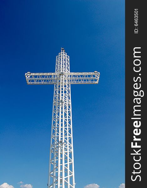 White steel cross on top of the mountain