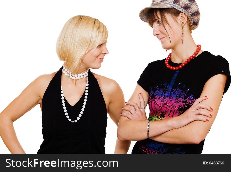 Two young girls looking at each other on white background
