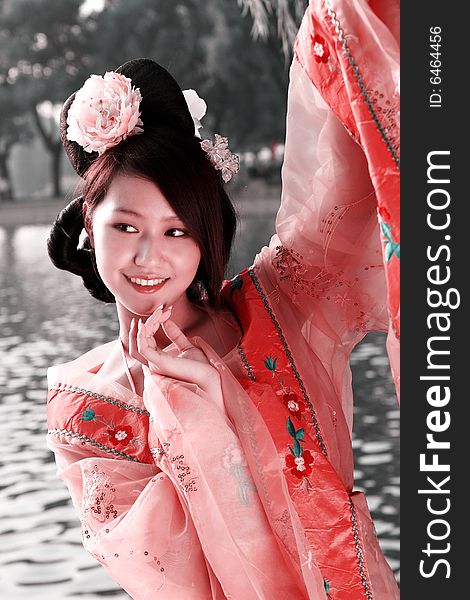 A girl in Chinese ancient dress. She wave pleasant posture. A girl in Chinese ancient dress. She wave pleasant posture..