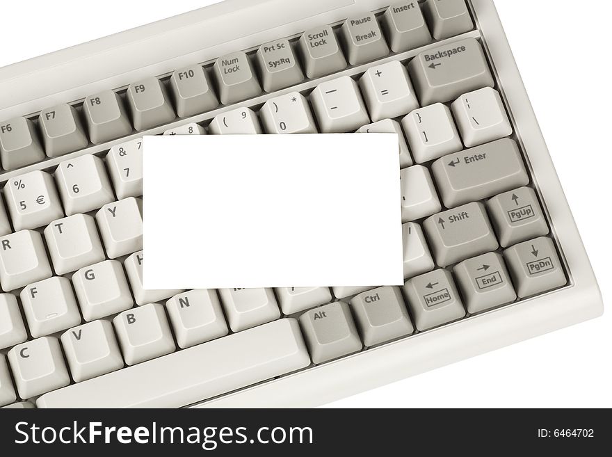 Close up of a computer keyboard and blank business card