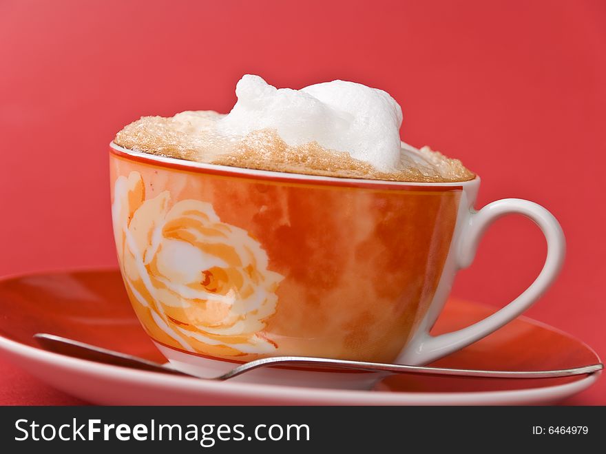 A cup of cappuccino with milk foam