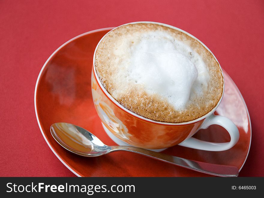 A cup of cappuccino with milk foam.