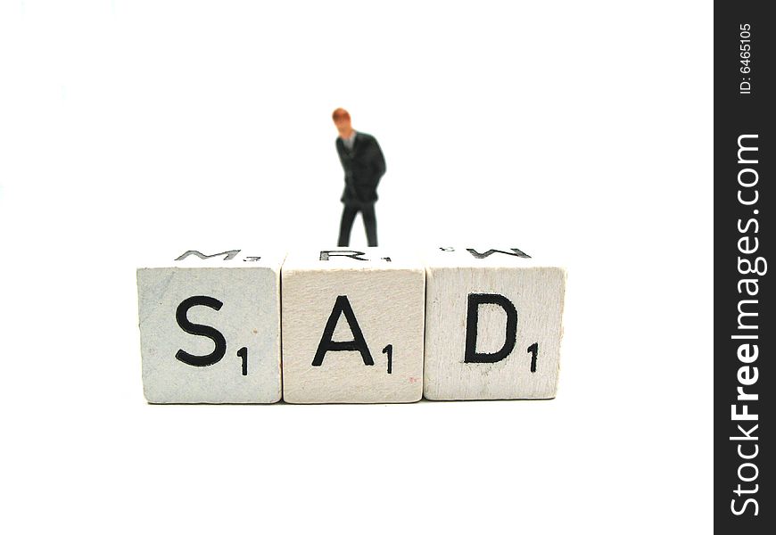 A man walking behind the word sad