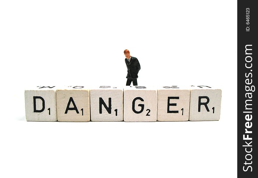 A figurine behind the word danger