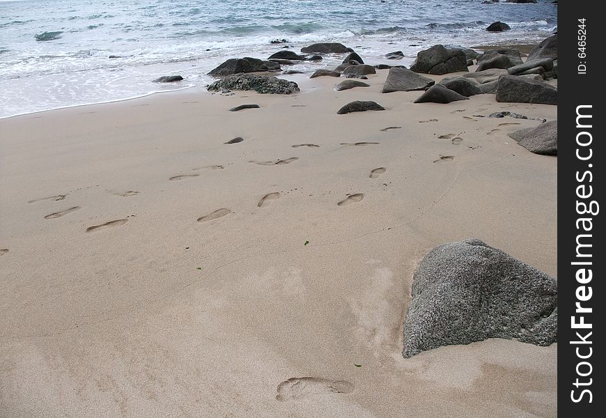 Praa Sands beach in Cornwall, sea, rocks and sand with footprints. Praa Sands beach in Cornwall, sea, rocks and sand with footprints.