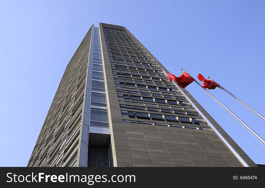 Office building with blue sky,Flags in front of the building. Office building with blue sky,Flags in front of the building