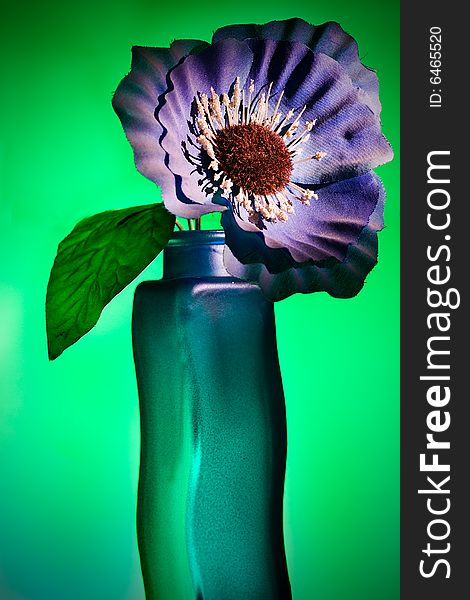 Blue artificial flower on green background. Blue artificial flower on green background