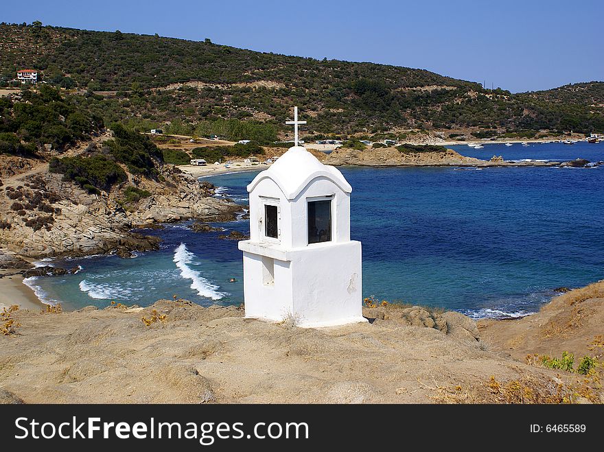 A white shrine in Sarti Beach overlooking the sea. A white shrine in Sarti Beach overlooking the sea.