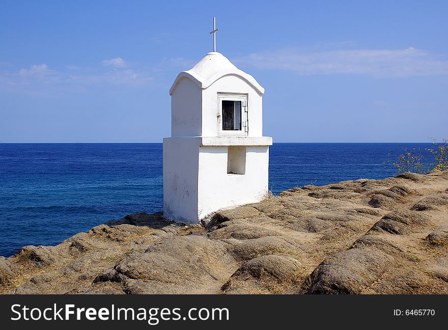 A white shrine in Sarti Beach overlooking the sea. A white shrine in Sarti Beach overlooking the sea.