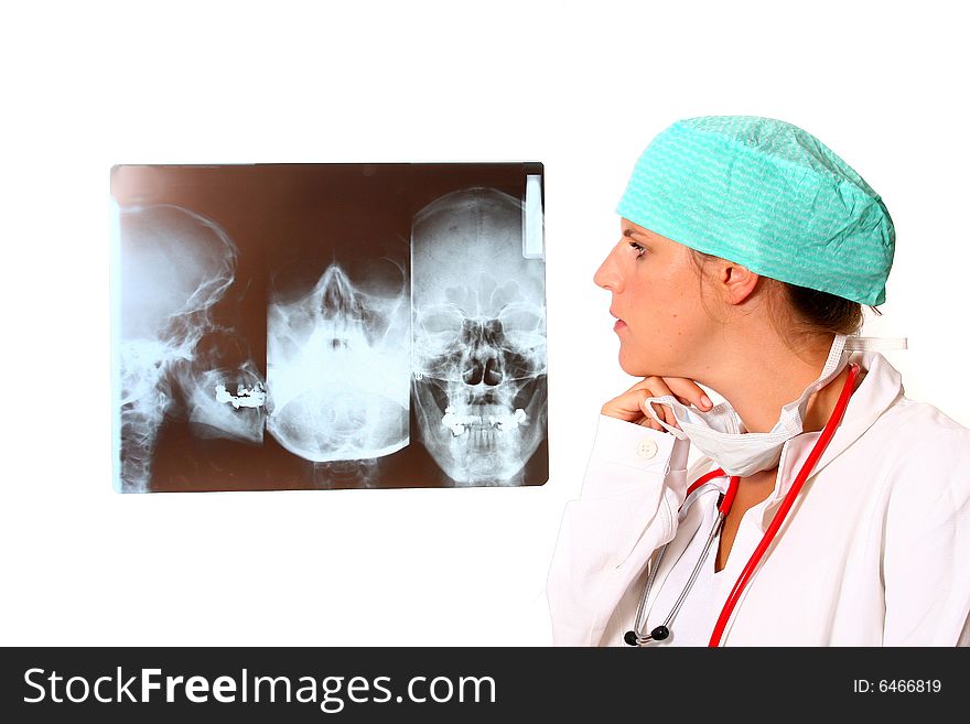 A young female doctor with a x-ray in the background and a stethoscope around the neck! Isolated over white. A young female doctor with a x-ray in the background and a stethoscope around the neck! Isolated over white.